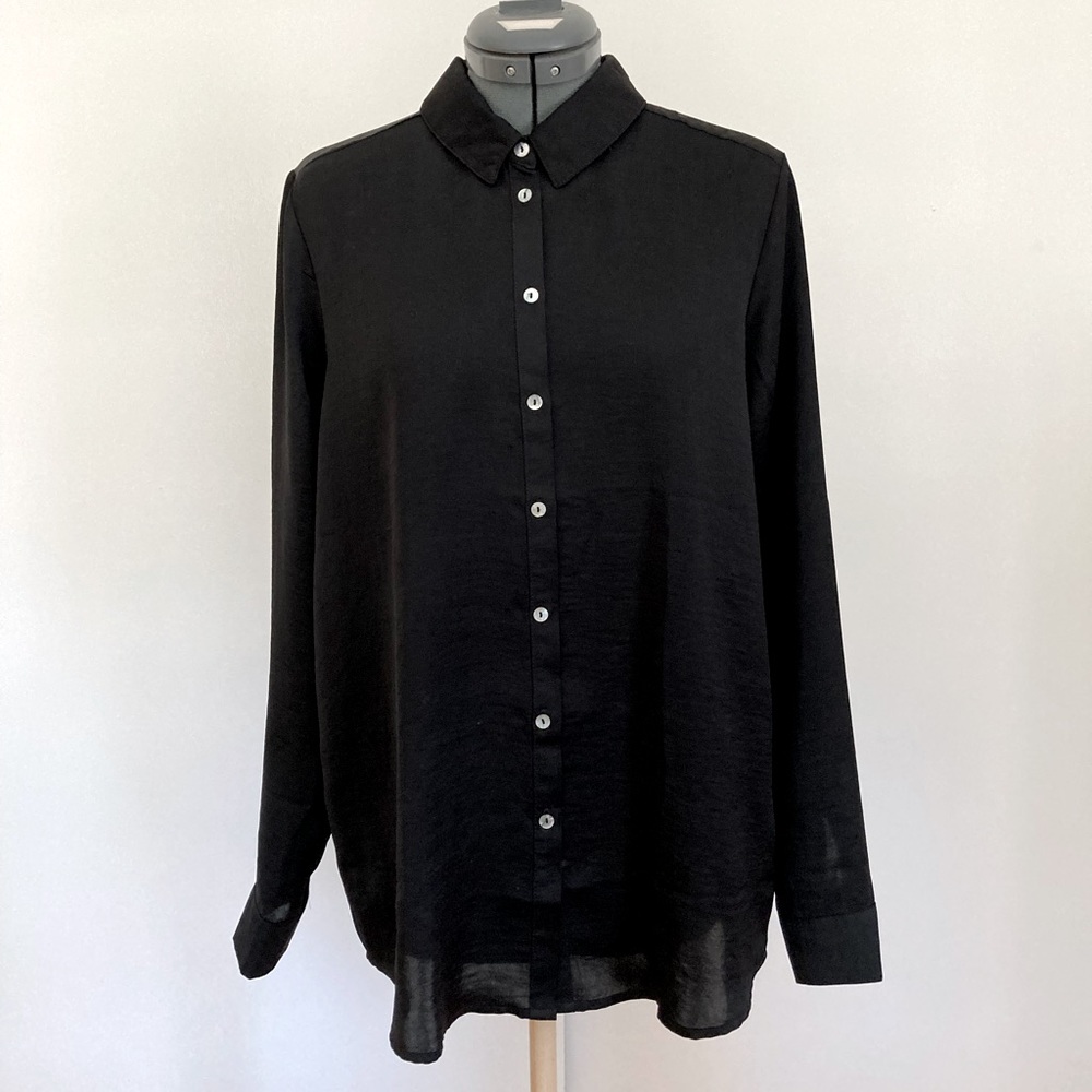 Silky, black collared shirt.